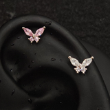 Titanium butterfly marquise CZ piercing studs in pink and white worn on ear cartilage helix, silver tone flat-back labret with marquise wing and round body CZ stones